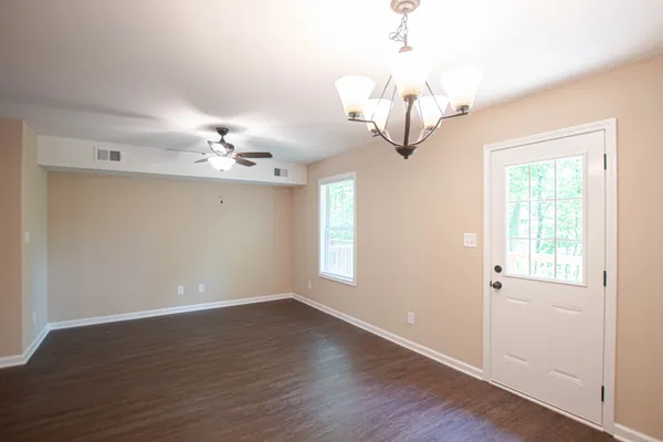 a view of wooden floor and chandelier in a room