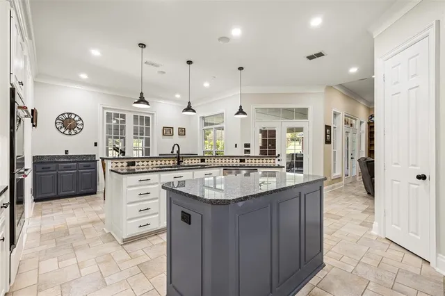 a kitchen with stainless steel appliances granite countertop a sink and cabinets