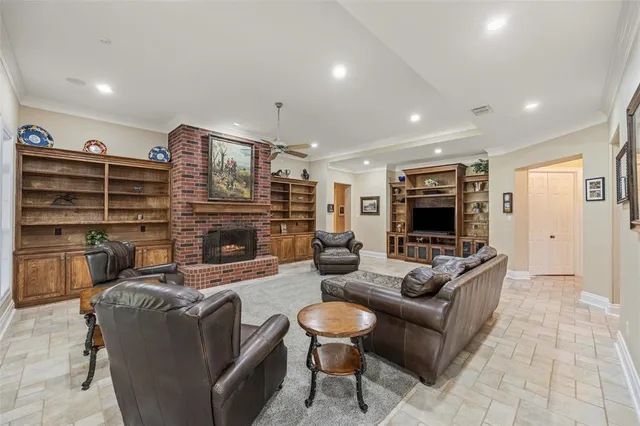 a living room with fireplace furniture and a flat screen tv