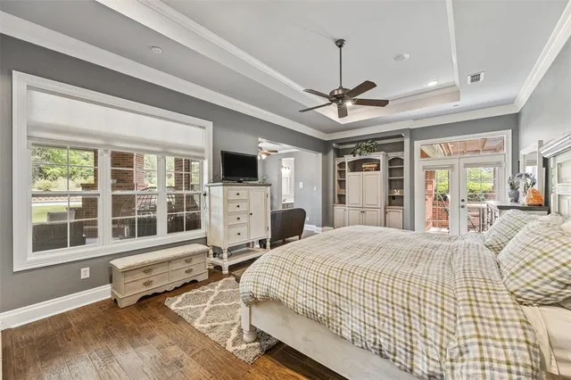 a bedroom with furniture window and flat screen tv