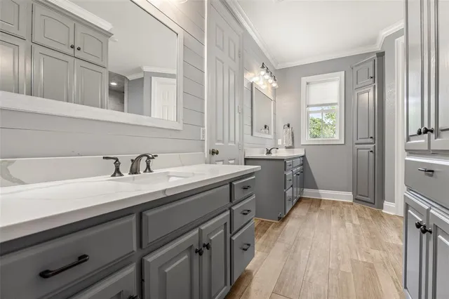 a spacious bathroom with a granite countertop sink mirror and