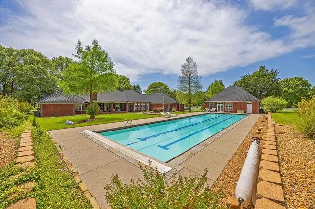 a view of swimming pool with a bench in front of it