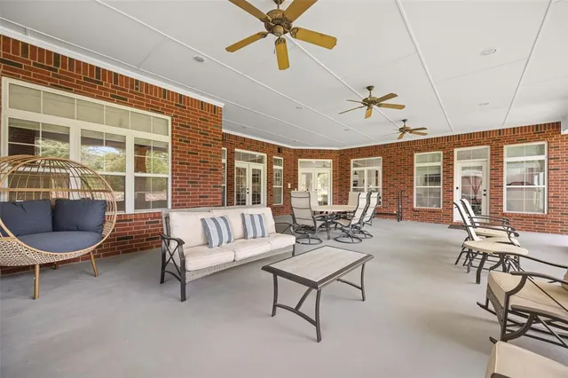 a living room with furniture and floor to ceiling windows