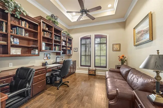 a view of a livingroom with workspace and a window