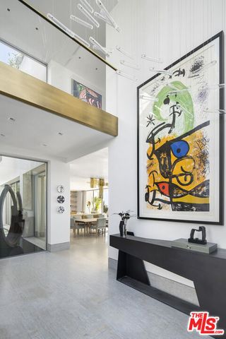 a dining hall with stainless steel appliances granite countertop a table and chairs