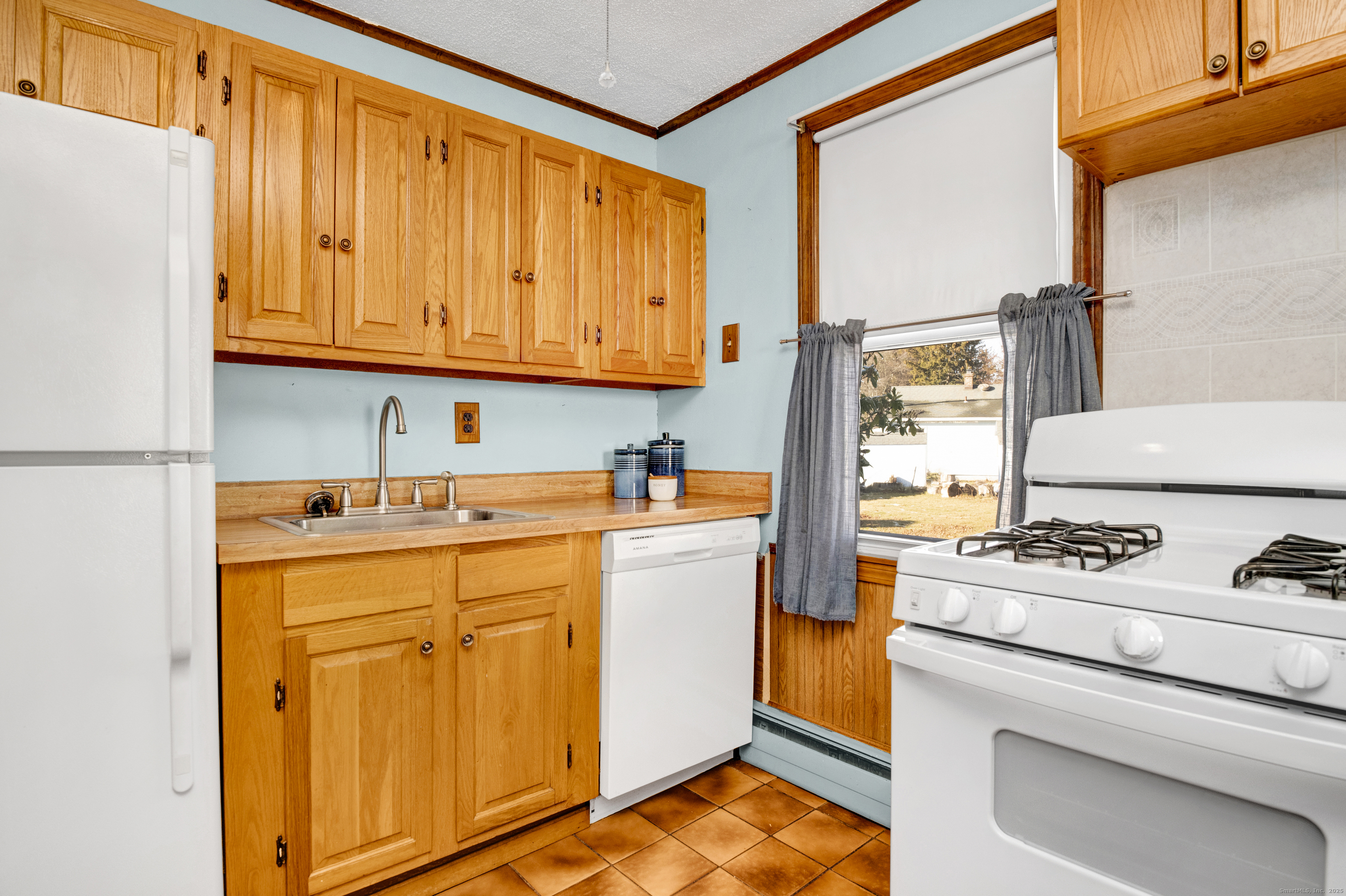 75 Lafayette Street Hartford, CT 06106 - Photo 20 of 38 a kitchen with a stove top oven sink and cabinets