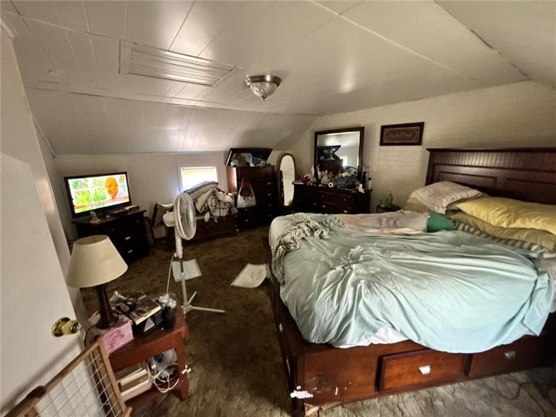 170 Portman Street McKees Rocks, PA 15136 - Photo 13 of 24 a bedroom with a bed mirror and lamp