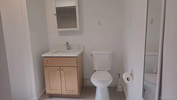 a bathroom with a sink toilet and mirror