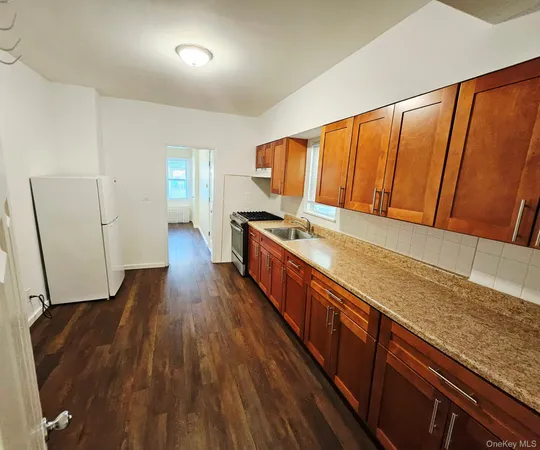 a view of a kitchen with wooden floor and staircase