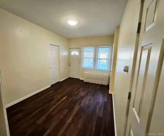 a view of a room with wooden floor and window