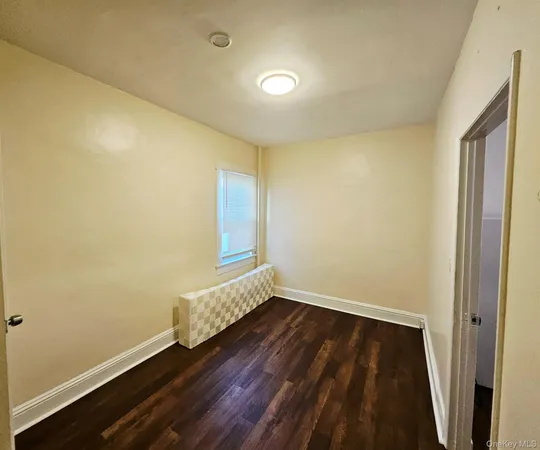 a view of room with window and hardwood floor