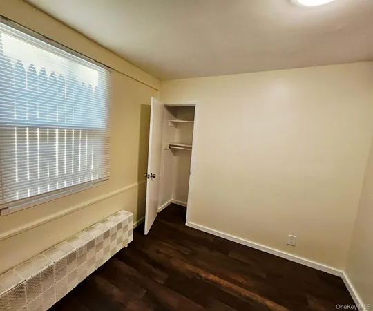 a view of an empty room and wooden floor