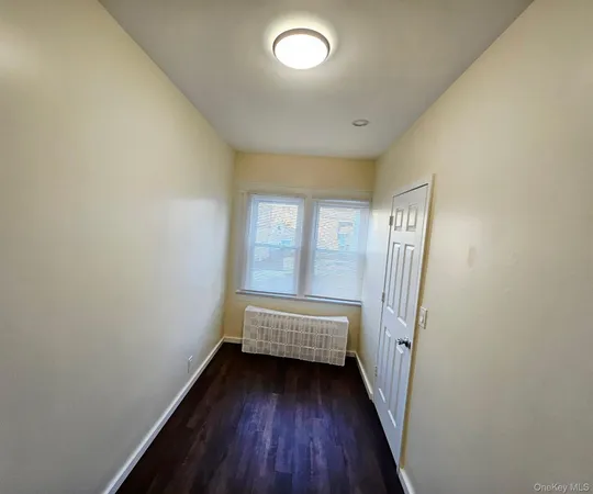 a view of a room with wooden floor and window