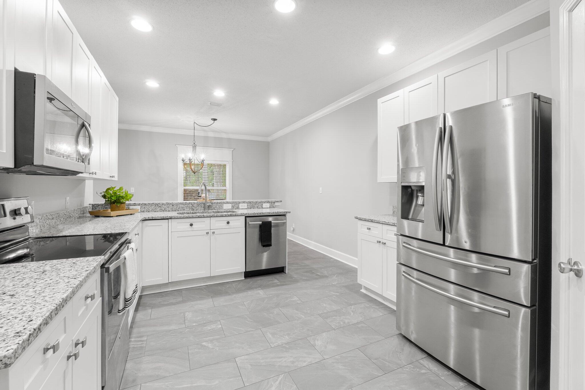 1083 Bay Grove Road Freeport, FL 32439 - Photo 11 of 41 a kitchen with a refrigerator sink and microwave