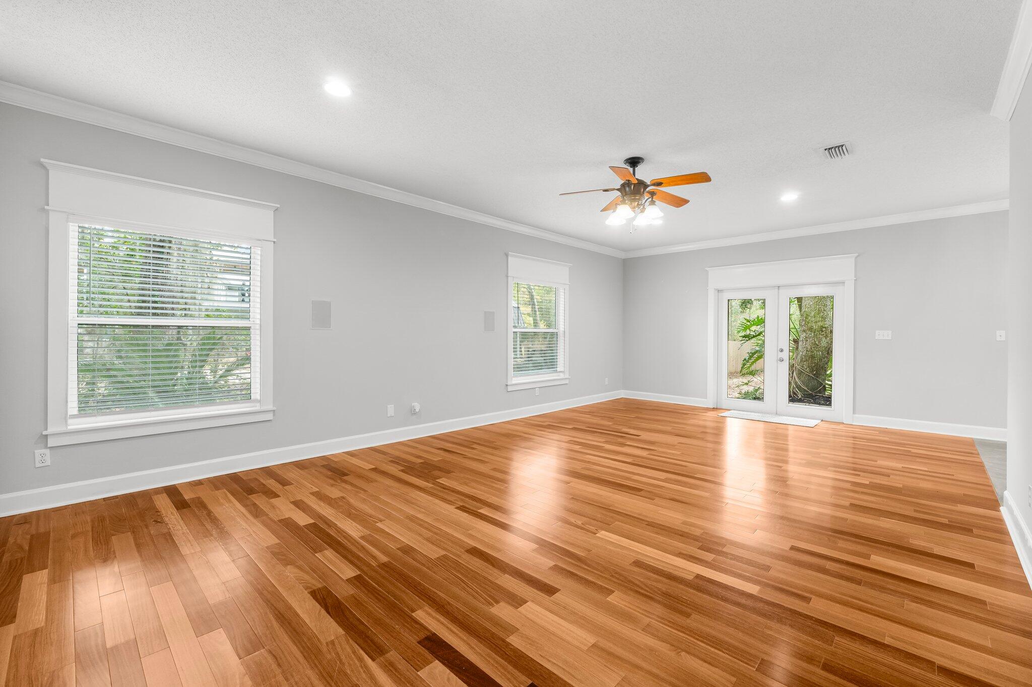 1083 Bay Grove Road Freeport, FL 32439 - Photo 8 of 41 an empty room with wooden floor and windows