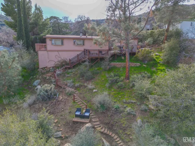 a view of a balcony with wooden floor and outdoor seating