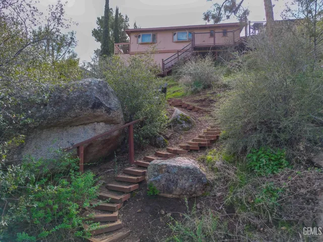 a view of a chairs and table in the balcony
