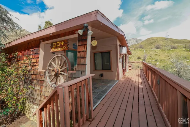 a view of balcony with wooden floor and outdoor seating
