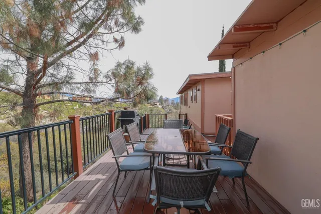 a view of a dining room with furniture a chandelier and wooden floor