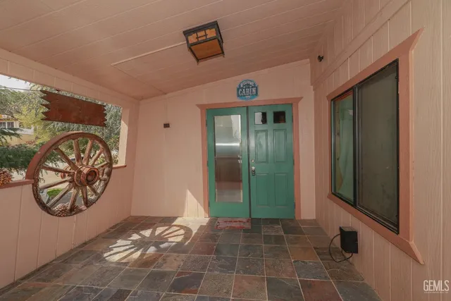 a kitchen with a sink a refrigerator and cabinets