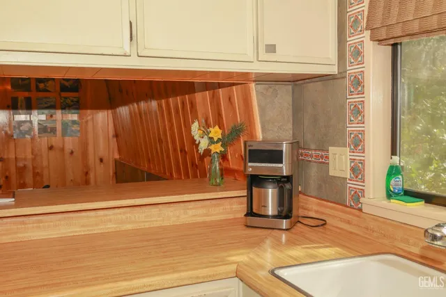 a view of a balcony with furniture and wooden floor