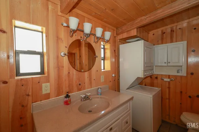 a view of a porch with a table and chairs and couches next to a yard