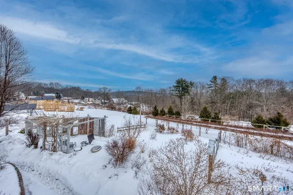 a view of a house with a snow in the yard