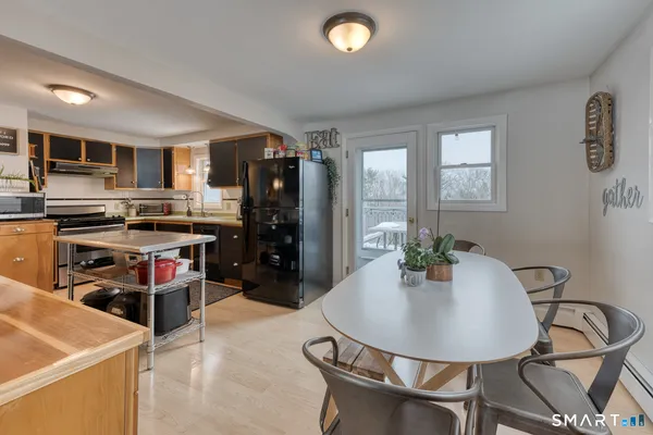 a kitchen with stainless steel appliances kitchen island granite countertop a refrigerator and a stove