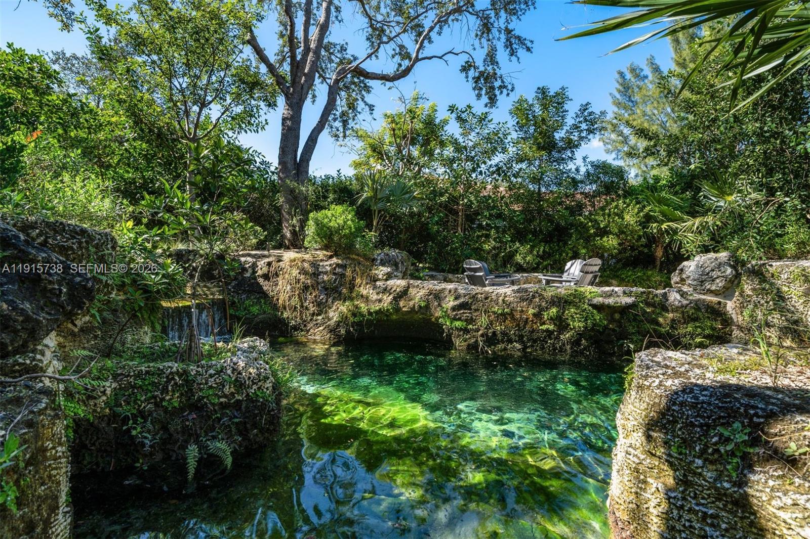 12050 Moss Ranch Road Pinecrest, FL 33156 - Photo 28 of 33 a view of a garden with plants and large trees
