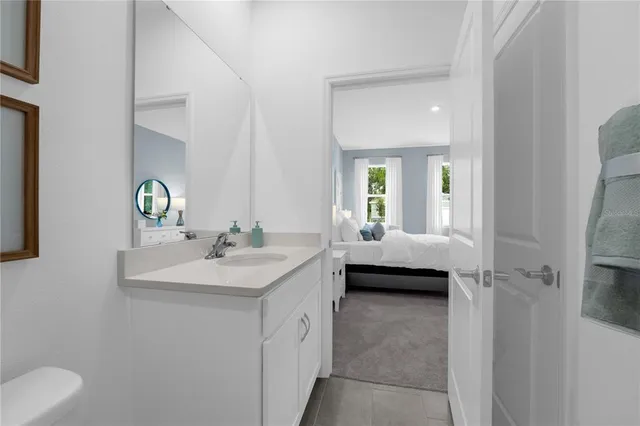 a en suite bathroom with a sink and a mirror