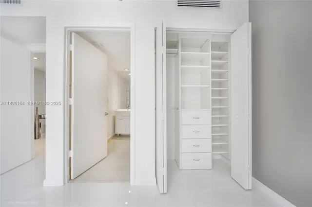 a bathroom with a shower sink vanity mirror and toilet