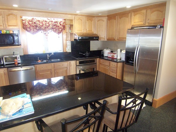 12 Atlas Road Braintree, MA 02184 - Photo 3 of 17 a kitchen with stainless steel appliances granite countertop a stove refrigerator sink and a granite counter tops