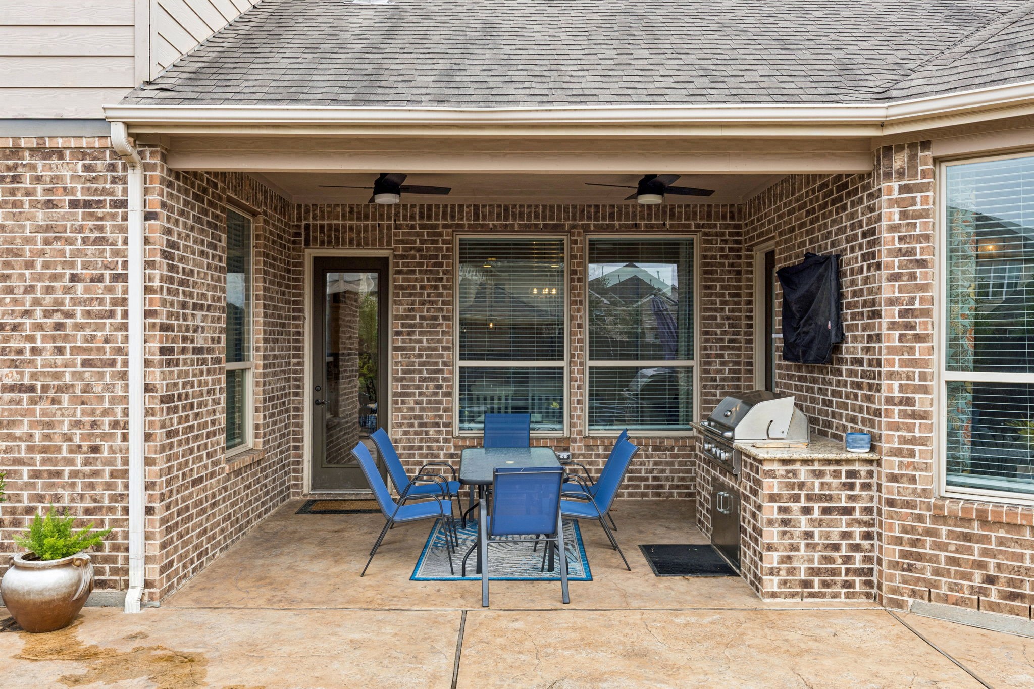1118 Fragile Sail Court Katy, TX 77494 - Photo 5 of 36 The expansive covered porch features a stone-wrapped outdoor kitchen.