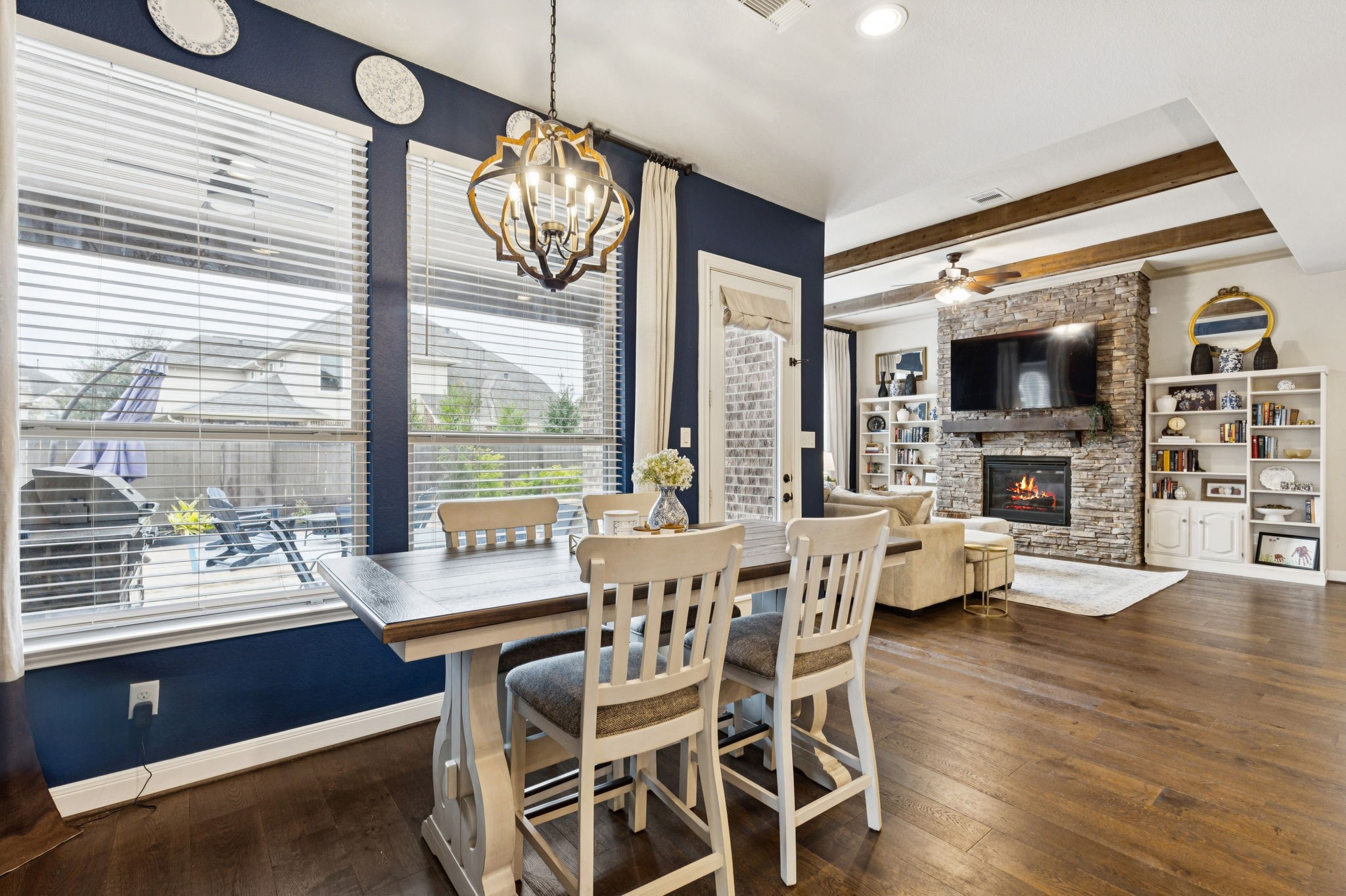1118 Fragile Sail Court Katy, TX 77494 - Photo 9 of 36 A light-filled breakfast room offering a seamless flow into the grand family room, featuring rich laminate flooring, a designer wood-beamed ceiling, and views of your private backyard oasis.