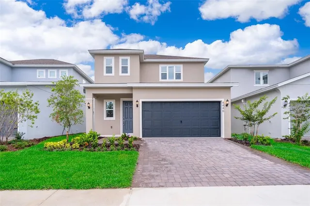 a front view of a house with a yard and garage