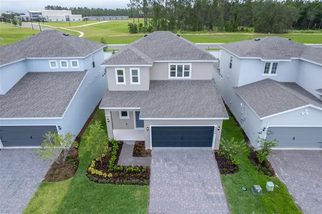 an aerial view of a house with a yard and a swimming pool
