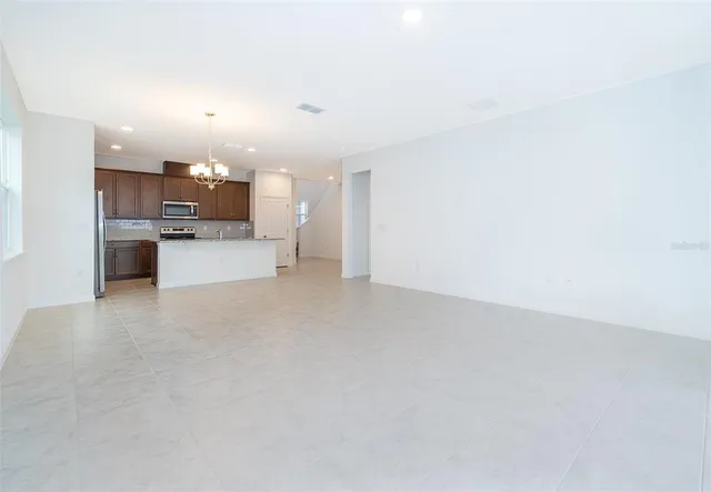 a view of kitchen and kitchen with microwave