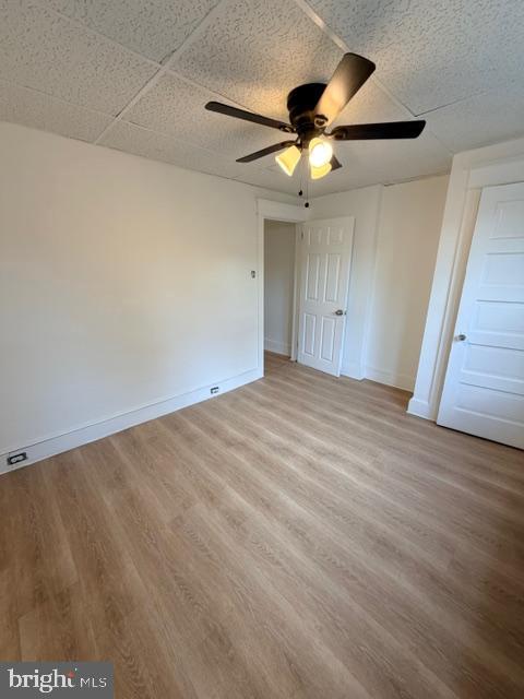 1424 Huddell Avenue Marcus Hook, PA 19061 - Photo 14 of 20 an empty room with wooden floor ceiling fan and windows
