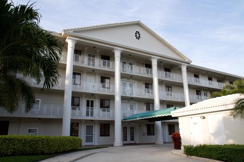 6169 Balboa Circle, Unit 203 Boca Raton, FL 33433 - Photo 2 of 19 a front view of a building with a garden