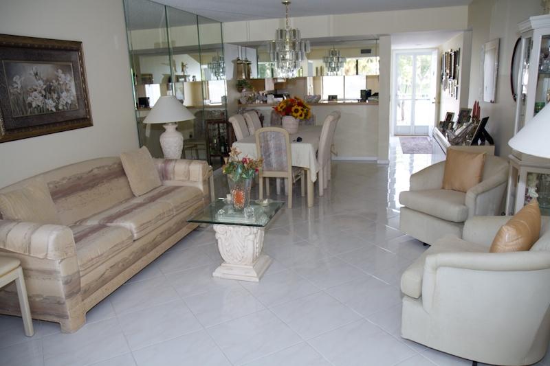 6169 Balboa Circle, Unit 203 Boca Raton, FL 33433 - Photo 12 of 19 a living room with furniture and a chandelier