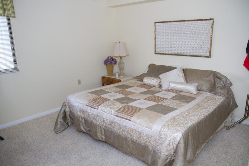 6169 Balboa Circle, Unit 203 Boca Raton, FL 33433 - Photo 13 of 19 a bedroom with a bed and lamp