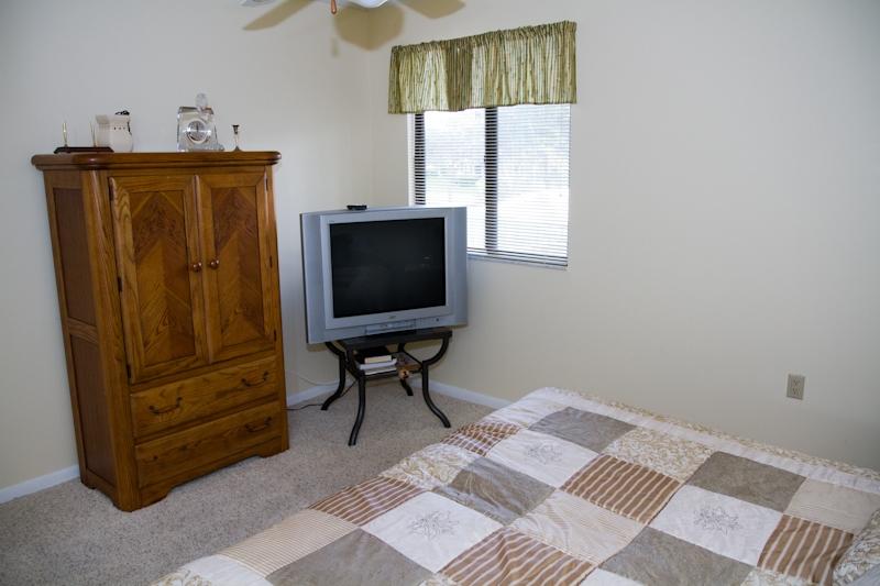 6169 Balboa Circle, Unit 203 Boca Raton, FL 33433 - Photo 14 of 19 a bedroom with a bed and a television