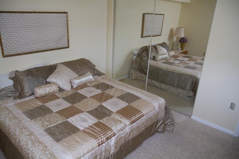 6169 Balboa Circle, Unit 203 Boca Raton, FL 33433 - Photo 15 of 19 a bedroom with a bed and wooden floor