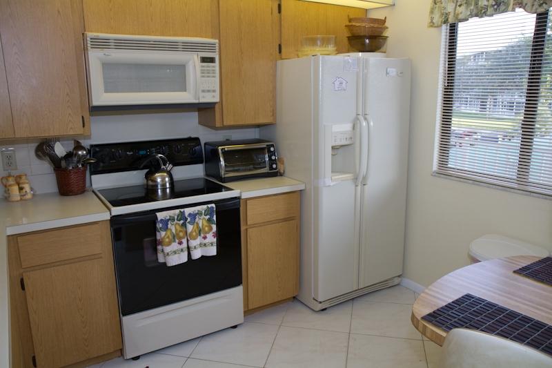 6169 Balboa Circle, Unit 203 Boca Raton, FL 33433 - Photo 18 of 19 a kitchen with a refrigerator and a stove