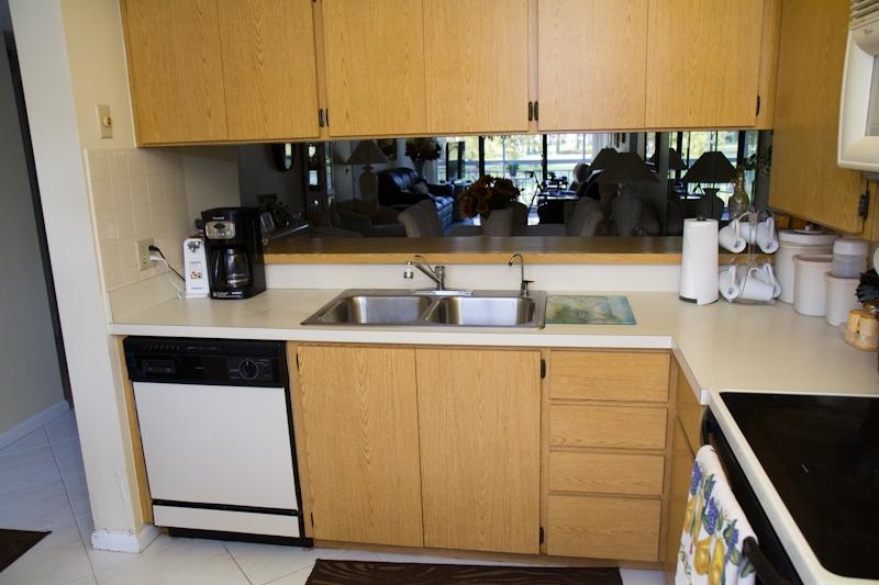 6169 Balboa Circle, Unit 203 Boca Raton, FL 33433 - Photo 19 of 19 a kitchen with a sink and cabinets