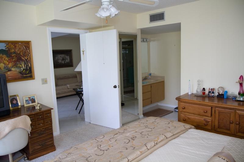 6169 Balboa Circle, Unit 203 Boca Raton, FL 33433 - Photo 7 of 19 a bedroom with a bed and a couch