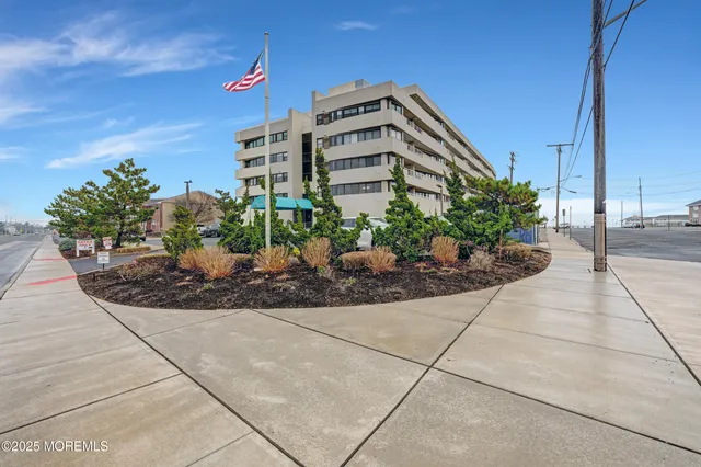 a front view of building with potted plants