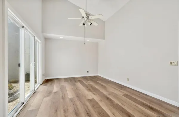 a view of a room with a ceiling fan