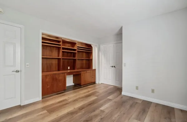 a view of an empty room and wooden floor