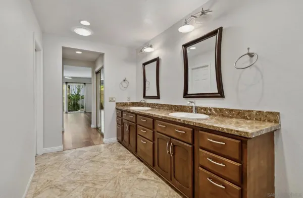 a spacious bathroom with a granite countertop sink a mirror and a